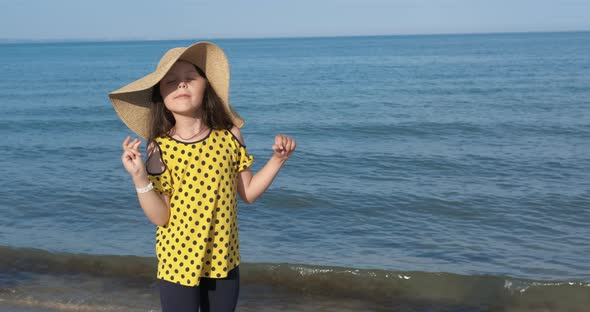 Child in Summer Hat on Beach