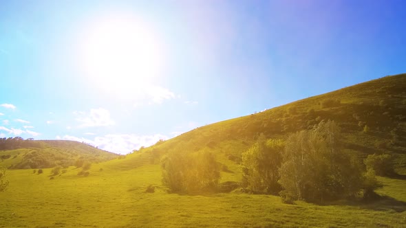  UHD Mountain Meadow Timelapse at the Summer. Clouds, Trees, Green Grass and Sun Rays Movement.