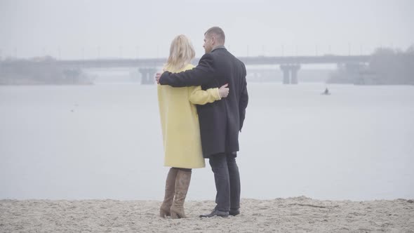 Wide Shot of Loving Adult Couple Standing on Riverbank and Talking