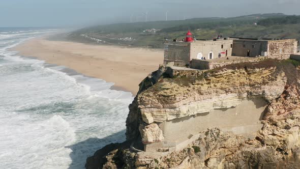 Portuguese Countryside with Waves Splashing Against Sandy Beach As Seen From Top