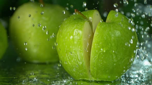 Super Slow Motion Shot of Falling Fresh Cutted Apple with Water Splashing at 1000Fps