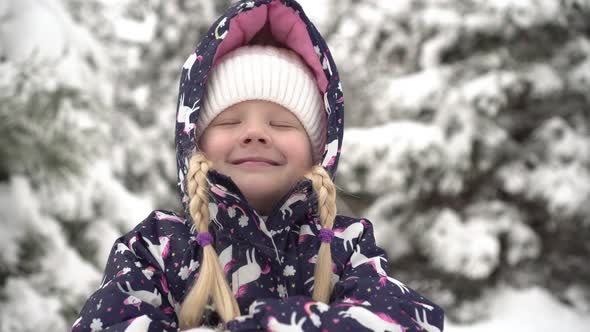 Portrait of a Happy Child Outdoors in Winter