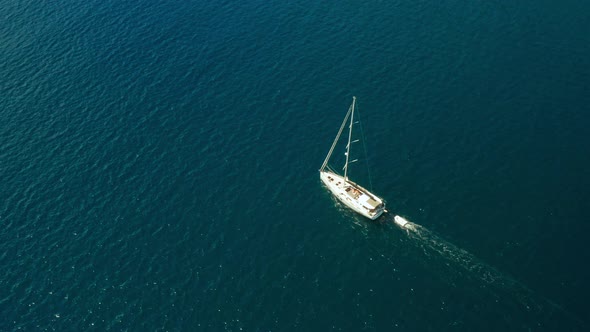 White Sailboat or Yacht Sails on the Sea with Blue Water