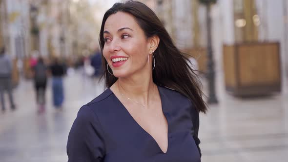 Smiling Woman Standing on Street and Looking at Camera