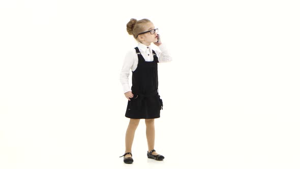 Little Business Girl Communicates By Mobile Phone on White Background