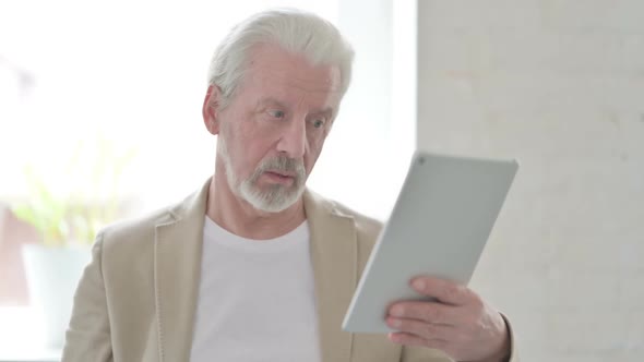 Video Call on Tablet By Old Man