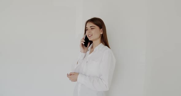 Pretty Young Girl Having Fun Talking on Smartphone She Smiling on Background