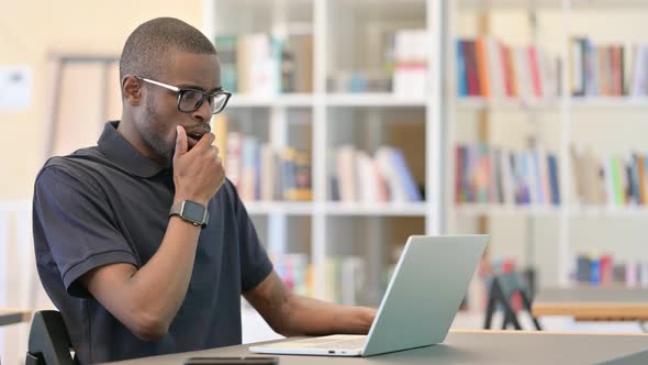 Worried Young African Man with Laptop Feeling Shocked on Laptop