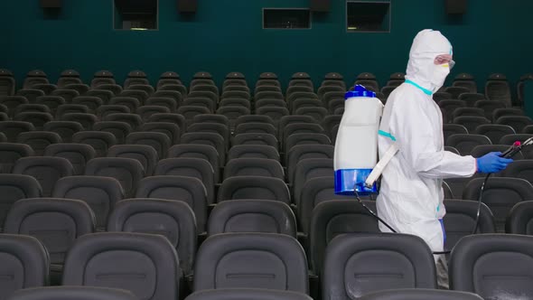 Worker Making Disinfection in Empty Cinema Hall