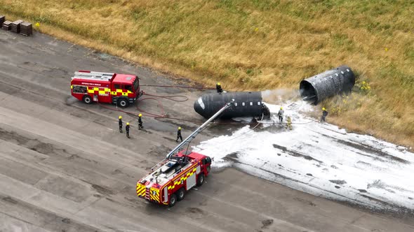 Firefighters Training to Tackle a Fire of a Dummy Aircraft