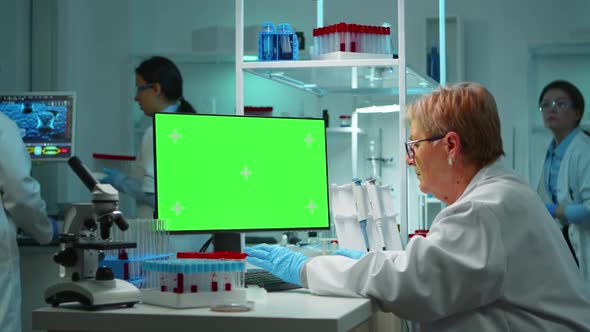 Elderly Researcher Looking at Chroma Key Display