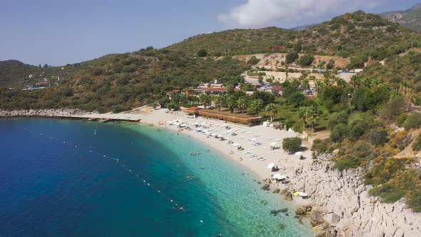 White Sand Hidayet Beach and Turquoise Sea Surrounded By Mountains in Kas Turkey