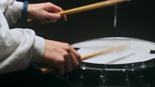 The Drummer Plays with Sticks on a Snare Drum Home Lesson Training