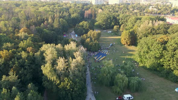 Aerial View of People Looking at How Hot Air Balloons Prepare for an Summer Evening Flying in Park
