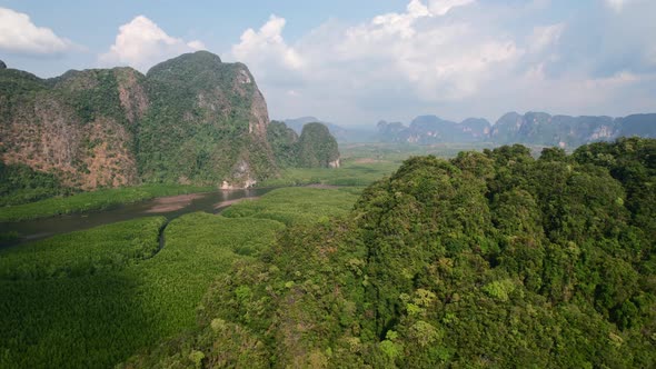 Drone flying over large mountains surrounded by rivers and mangroves in Ao Thalane Krabi Thailand on