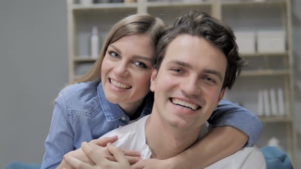 Smiling Romantic Young Couple in Love Looking at Camera