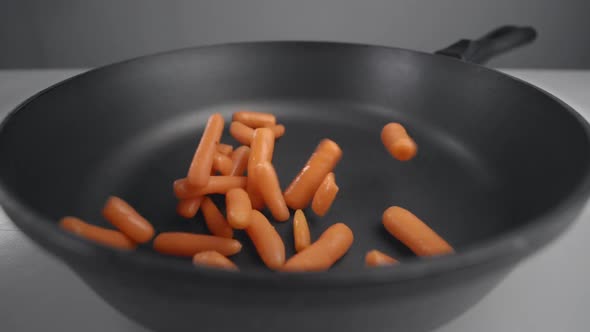 Small Carrots Are Falling in Slow Motion To the Pan, Fresh Vegetables Are Falling in 240 Fps