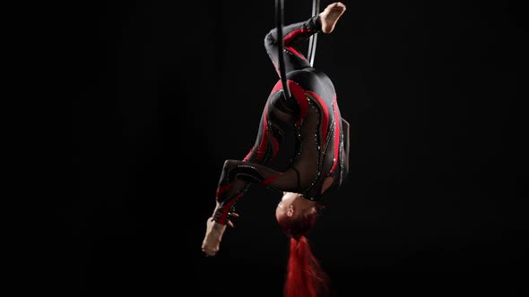 Wide Shot Flexible Young Woman Hanging on Air Hoop Upside Down Smiling and Looking at Camera