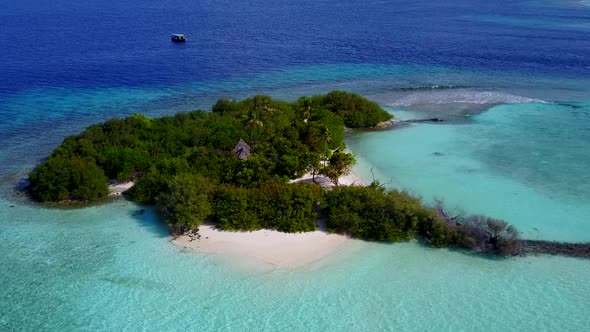 Aerial drone scenery of tourist beach break by blue water with sand background