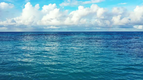 Wide angle flying island view of a paradise sunny white sand beach and aqua blue ocean background