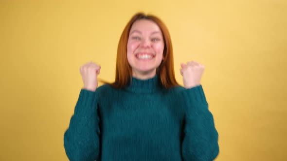 Young Red Hair Woman in Green Sweater Posing Isolated on Yellow Color Background Studio