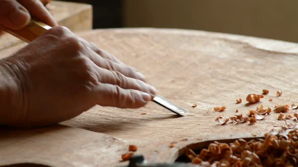 Luthier Working in a New Guitar