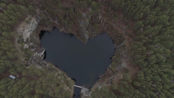 Flooded heart-like Lake Talc Stone  and rocks of talc. Aerial 02