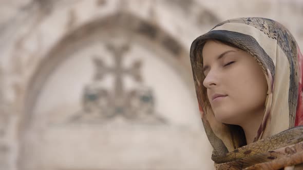 Woman with closed eyes praying