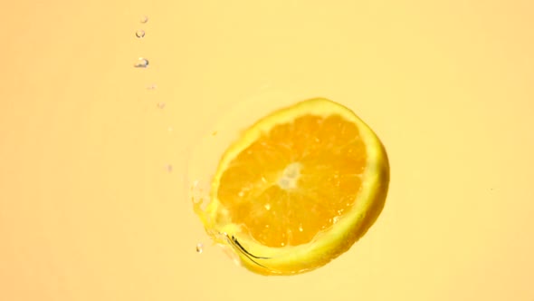 Sliced orange spinning in water, Slow Motion