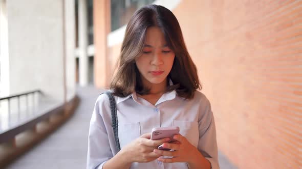 frustrated woman looking at phone