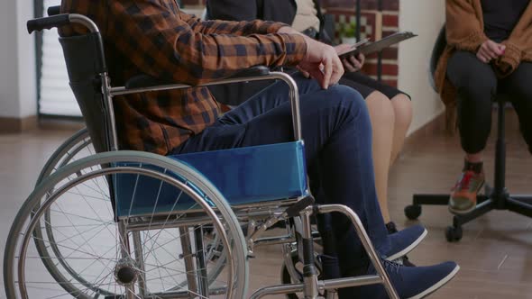 Close Up of Senior Man Sitting in Wheelchair and Receiving Advice From Counselor at Aa Group Therapy