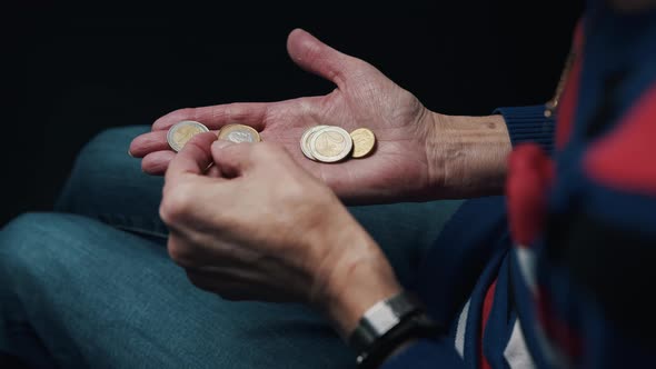 Old Woman Counting Coins in Her Wrinkled Hands