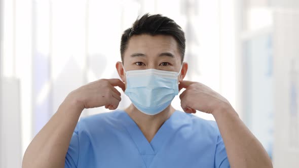 Portrait of Young Asian Doctor Take Off Medical Face Mask and Smile