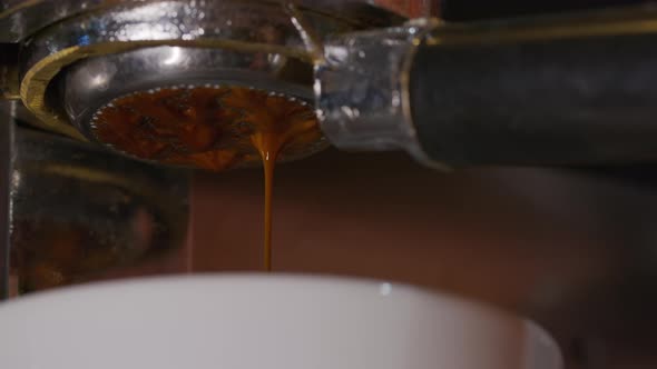 Close Up Slowmaton of Pouring Coffee Stream From Professional Machine.