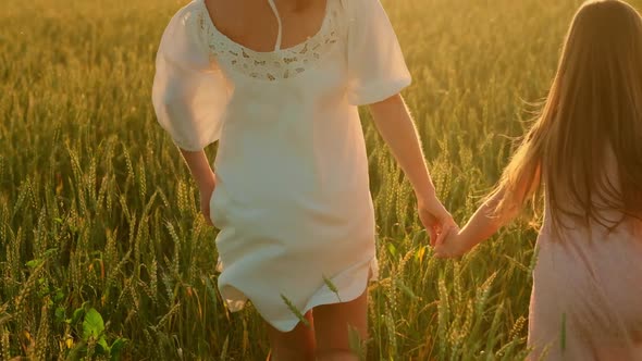 Woman and Girl in a Wheat Field Harvest at Sunset