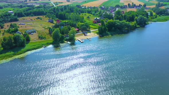 Epic Top Down Aerial View of Big Lake With Clear Blue Water. Reflection of Sky in Clear Lake in Even