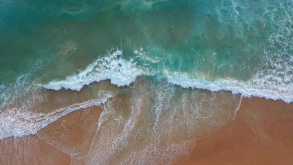 Aerial Top View White Foamy Waves Crash Along The Beach  1