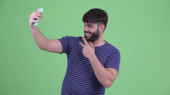 Happy Young Overweight Bearded Indian Man Taking Selfie