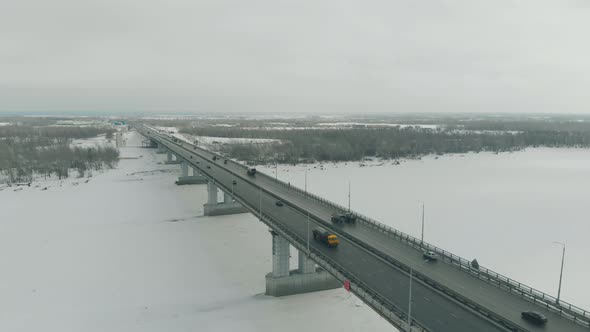 Flycam Films Fast Moving Transport Driving Along Wide Bridge