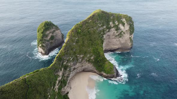 Top down view of Kelingking Beach in Nusa Penida Island, beautiful ocean with azure blue waves and m