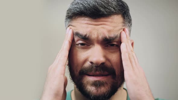 Man Feeling Severe Headache Caused by The Migraine, Close-Up Face with Emotion