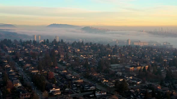 Stunning Sunset Fog over North Vancouver Neighborhood Homes and Rental Apartments in Canada - Drone
