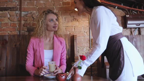 Woman At Cafe Drinking Coffee With Chocolate Candies