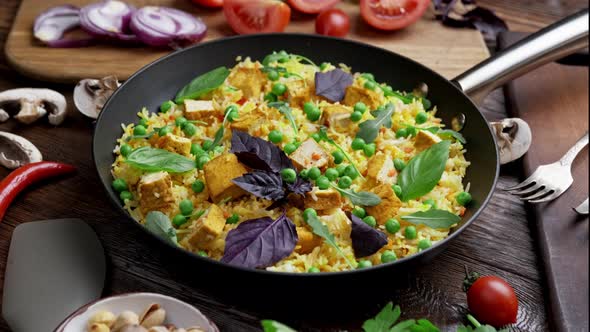 Vegetable Rice with Green Peas Rotates on a Wooden Board