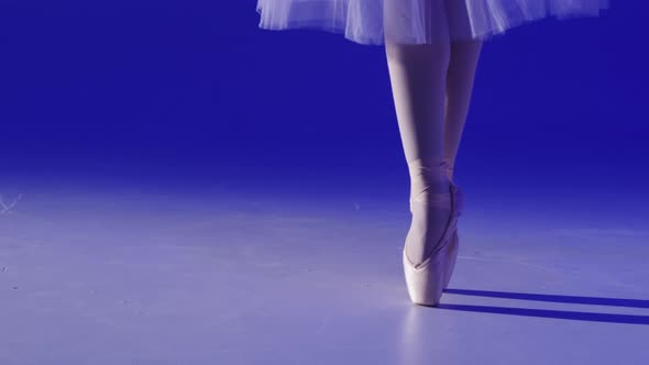 Ballerina Legs Closeup Dancing on Blue Background