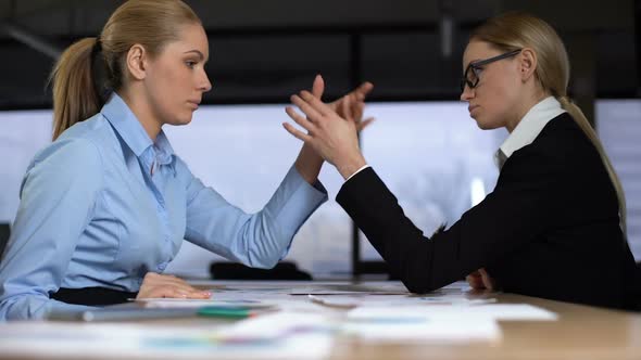 Two Businesswomen Doing Arm Wrestling in Office, Concept of Rivalry at Work