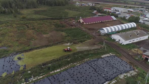 Aerial view of tractor dropping green silo. 04