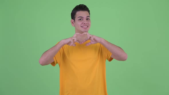 Happy Young Multi Ethnic Man with Hand Heart Gesture