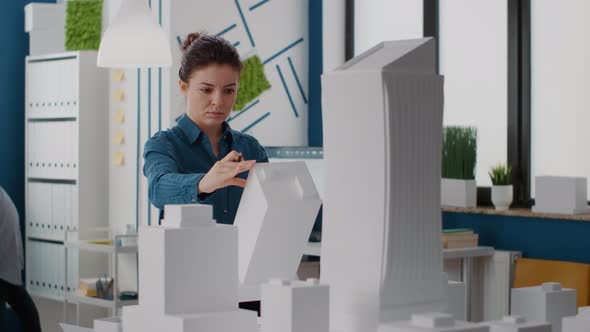 Portrait of Architect Looking at Building Model and Maquette to Plan Urban Project