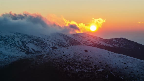 Sunset over Snowy Mountains in Winter